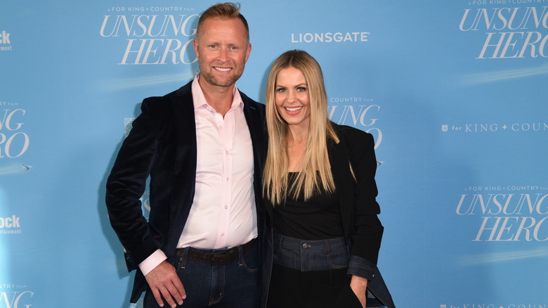 Candace Cameron Bure posing for a photograph next to her husband, Valeri Bure