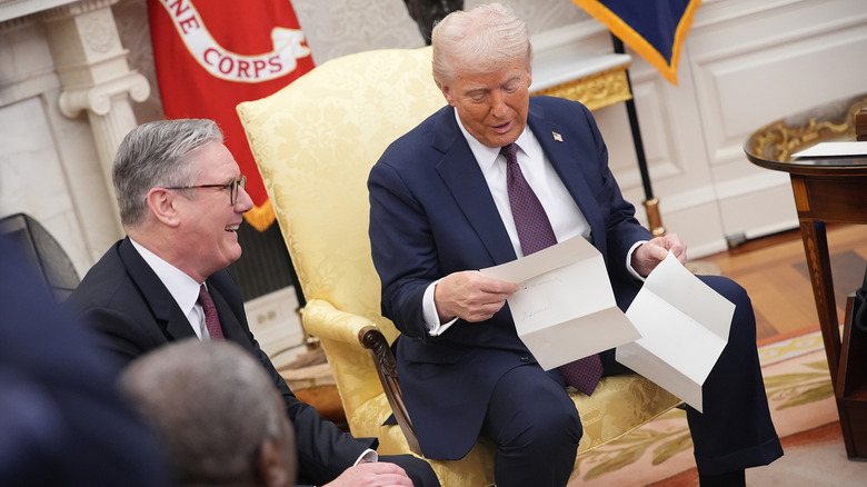 Donald Trump looking at King Charles III's letter