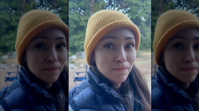 Autumn Reeser wearing a yellow hat and blue coat outside