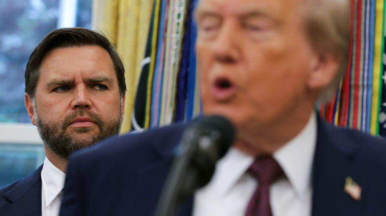 JD Vance glaring over his shoulder at an unfocused Donald Trump
