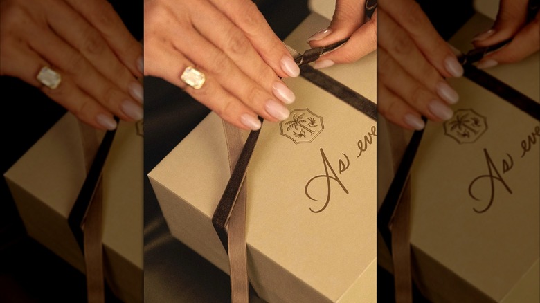 Meghan Markle's hands tying As ever box