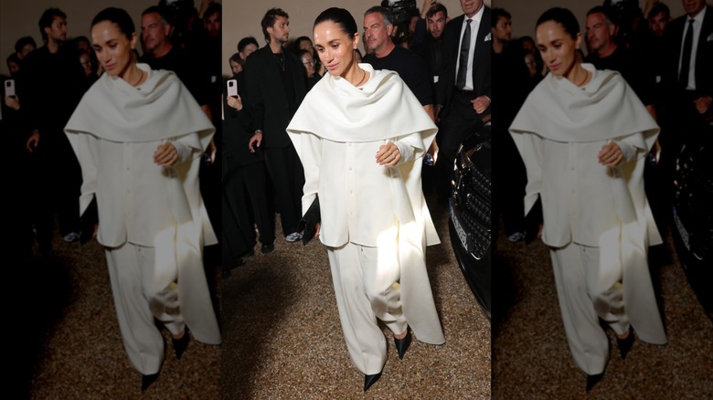 Meghan Markle leaving the Balenciaga fashion show in Paris wearing a white pant suit