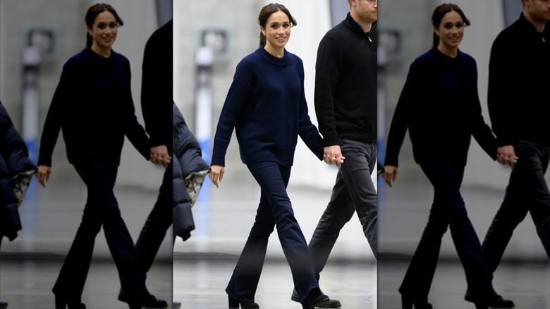 Meghan markle dressed in all blue as she holds hands and walks with Prince Harry