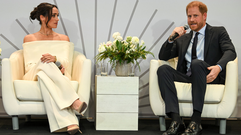 Meghan Markle and Prince Harry talking on stage