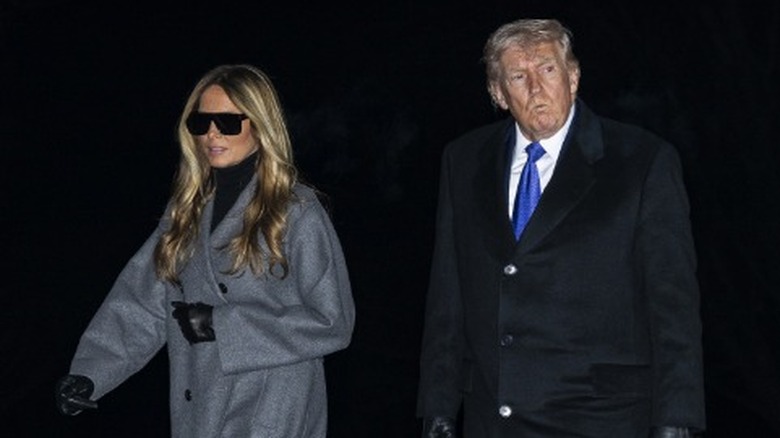 Melania Trump and Donald Trump walk on the South Lawn after returning to the White House (2026)