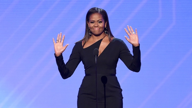 Michelle Obama smiling with microphone