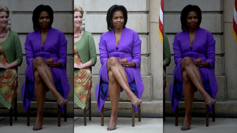 Michelle Obama sitting with her legs crossed