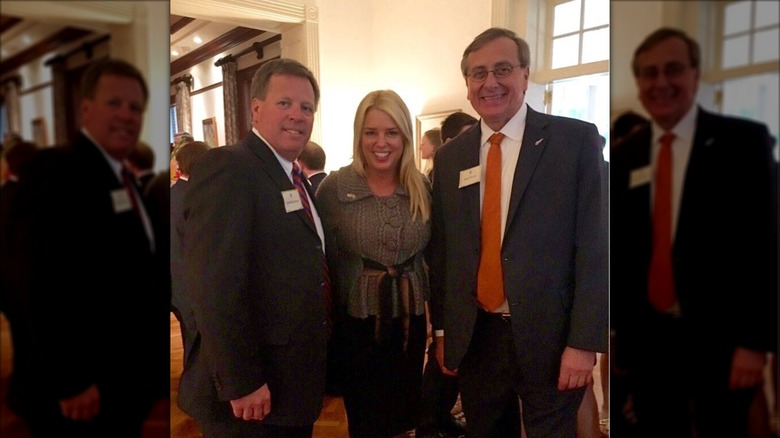Pam Bondi in standing between Coach Jim McElwain and President Kent Fuchs from University of Florida in 2016