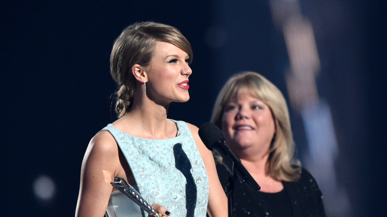 Taylor Swift photographed accepting the Milestone Award from Andrea Swift during the 50th Academy of Country Music Awards on April 19, 2015