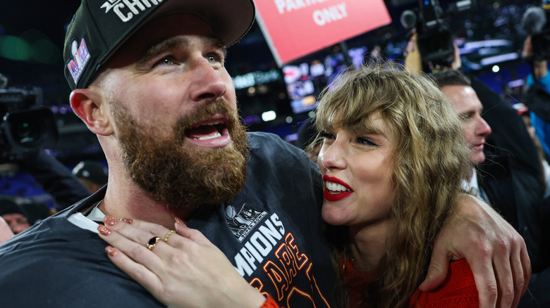 Travis Kelce and Taylor Swift celebrating the Chiefs' win at the AFC Championship Game on January 28, 2024
