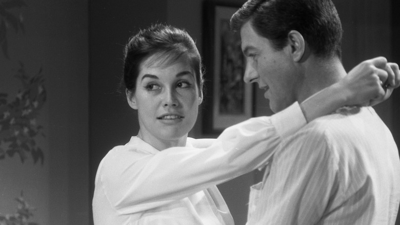 Mary Tyler Moore placing her arms on Dick Van Dyke's shoulders during rehearsal for "The Dick Van Dyke Show"