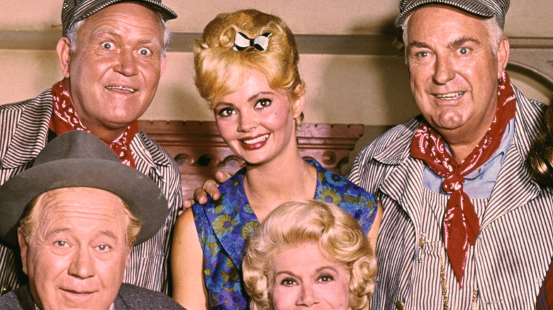 Jeannine Riley poses next to four of her costars in a floral dress