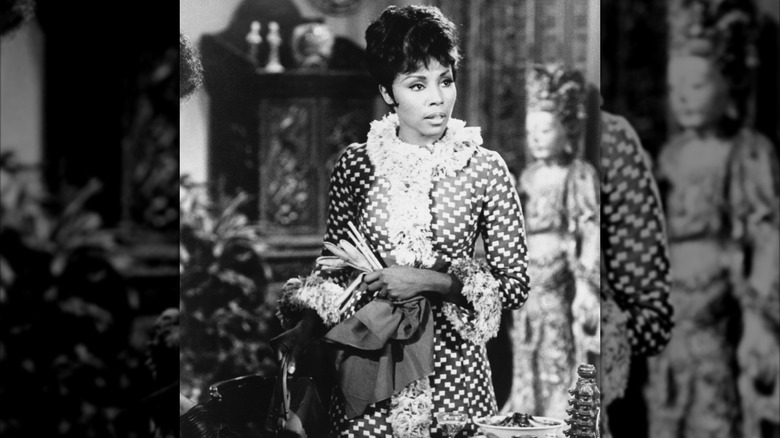 Diahann Carroll poses in a checkered penny lane coat