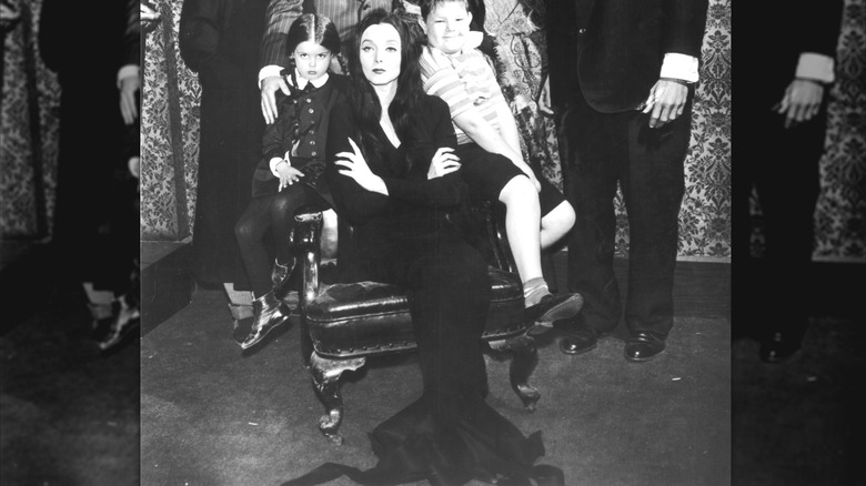 Carolyn Jones as Morticia Addams poses in a black dress