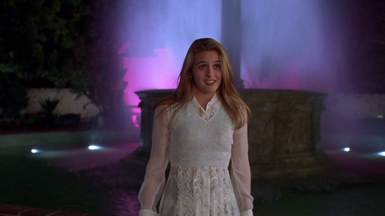 Cher walking in front of a fountain in Clueless