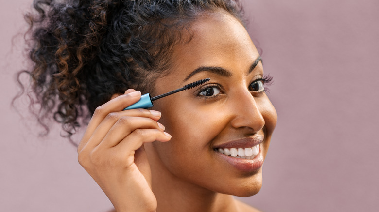 Woman applying mascara