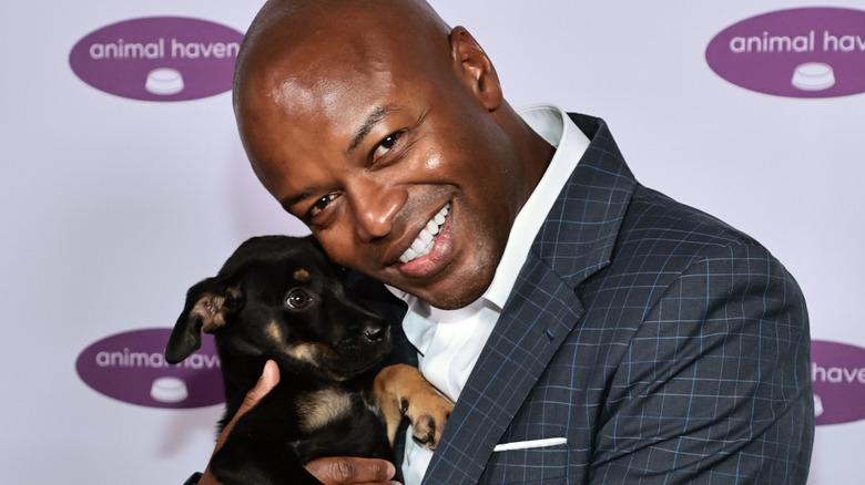 Kendis Gibson cuddling a puppy at an event