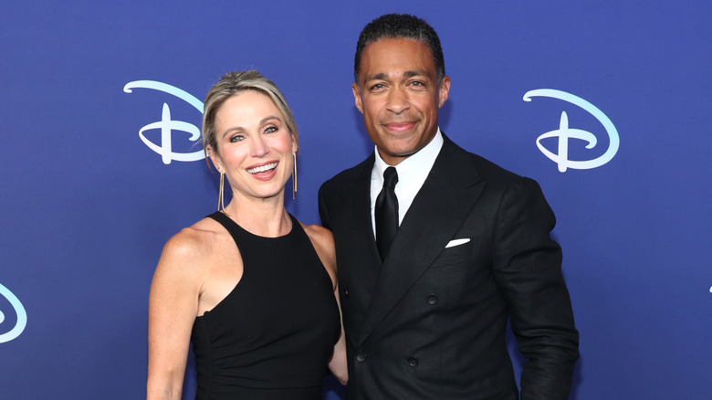 Amy Robach and T.J. Holmes posing on the red carpet