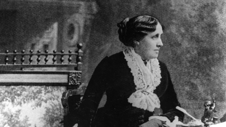 Louisa May Alcott sitting and looking to the side