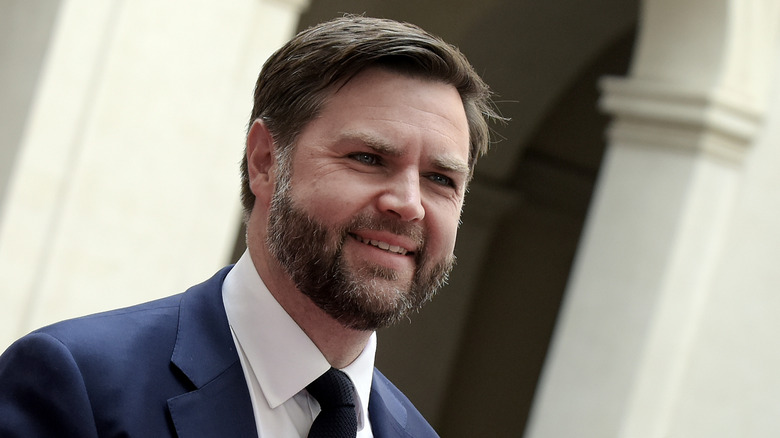 JD Vance smiles to the right in an angled photo of the VP.