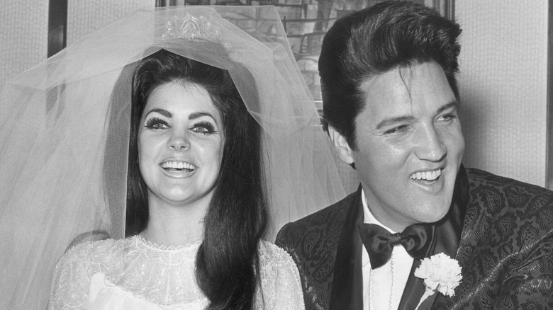 Elvis and Priscilla Presley smiling on their wedding day.