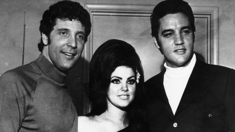 Tom Jones, Priscilla, and Elvis Presley posing together in 1971.