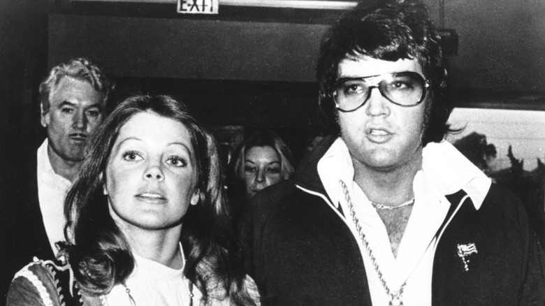 Priscilla and Elvis Presley leaving their divorce hearing in 1973