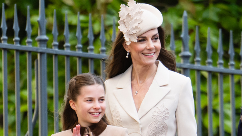 Prince Charlotte and Kate Middleton smile as they walk together