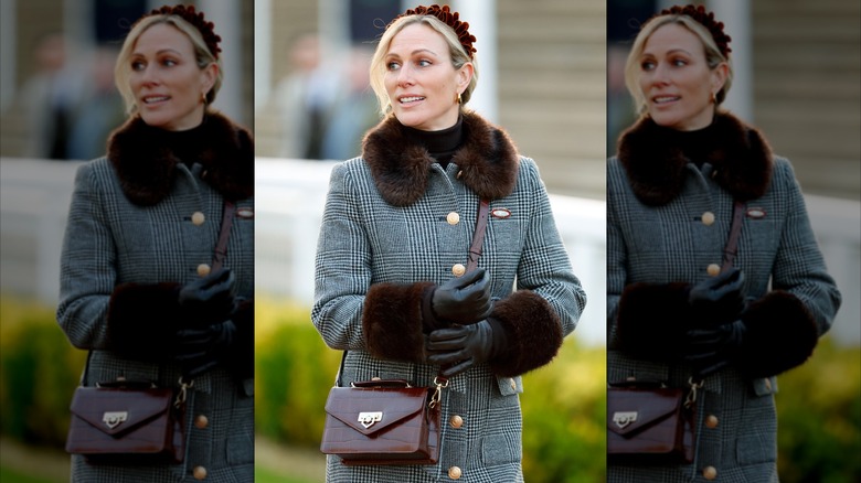 Zara Tindall wearing a fur-trimmed checked coat and a cross-body purse at Festival Trials Day at Cheltenham Racecourse