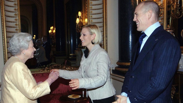 Queen Elizabeth II and Prince Philip, Duke of Edinburgh greet granddaughter Zara Phillips and her boyfriend Mike Tindall at an Achievers reception at Buckingham Palace (2006)