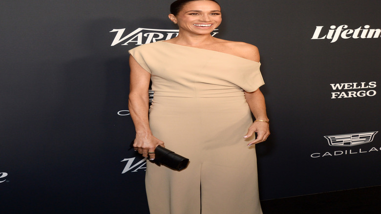 Meghan Markle wearing a beige dress with her hair in a slick bun at a Variety event