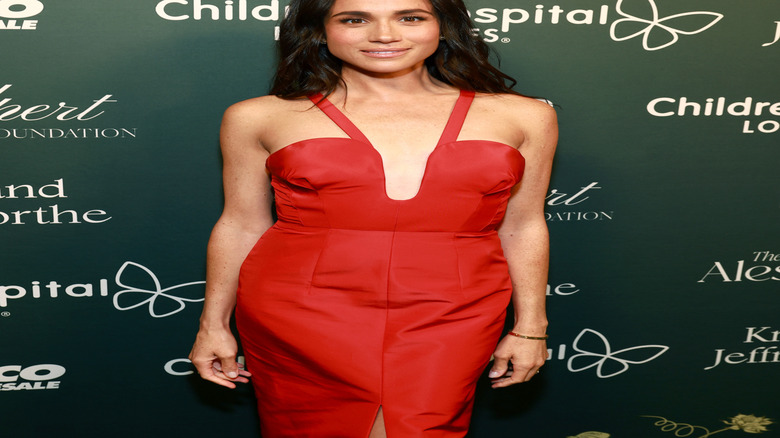 Meghan Markle wearing a plunging red dress at a gala in 2024