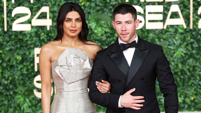 Priyanka Chopra and Nick Jonas posing on a 2024 red carpet