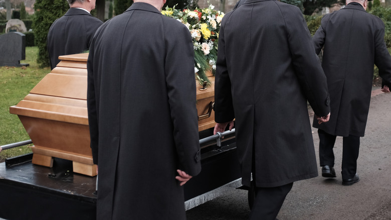 pallbearers carrying a casket