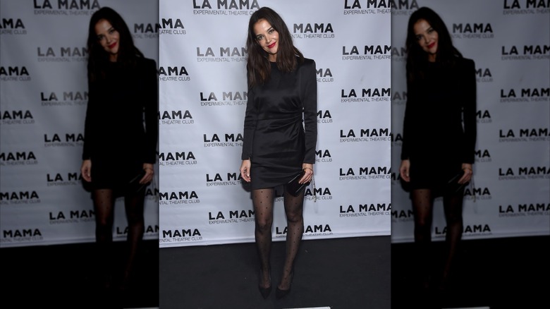 Katie Holmes in a black dress and tights