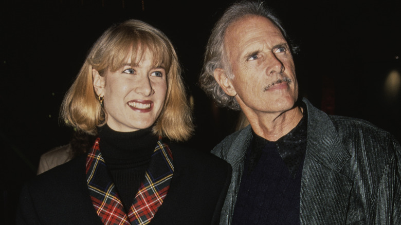 Laura Dern, wearing a black jacket with tartan lapels, and her father, American actor Bruce Dern, who wears a grey jacket over a black top, attend the World Premiere of 'Rush', held at the Galaxy Theatre in the Hollywood neighbourhood of Los Angeles, California, 18th December 1991.