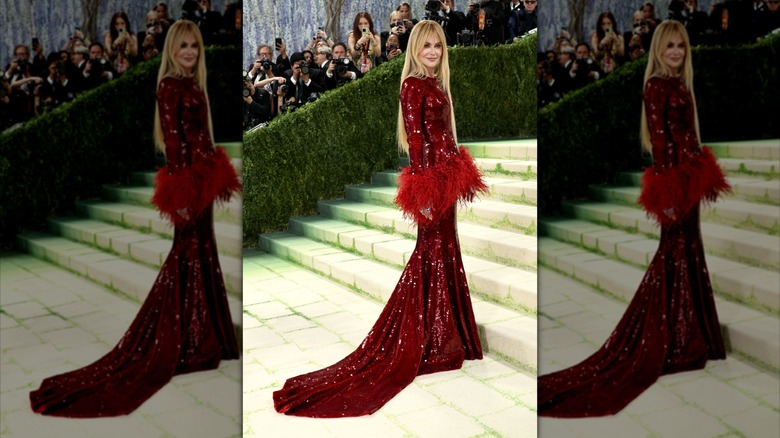 Nicole Kidman poses in a red sparkly gown on stairs