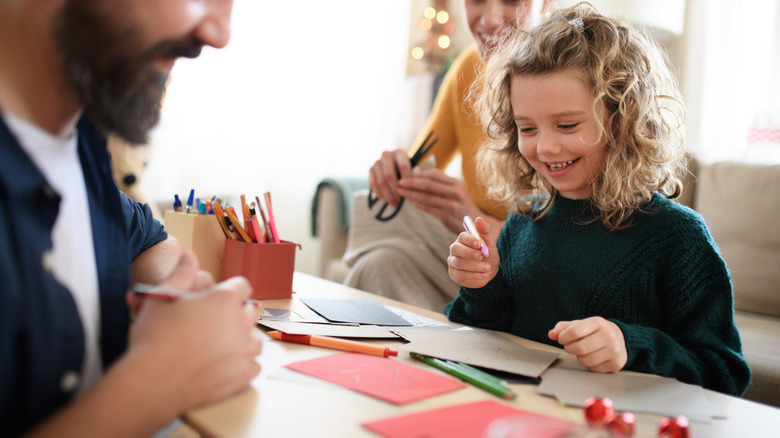 girl, mother and father design homemade holiday cards