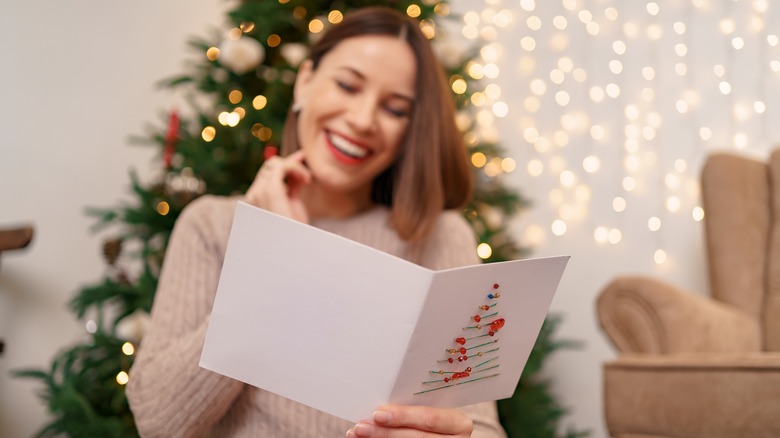 Woman laughing reading a Christmas card