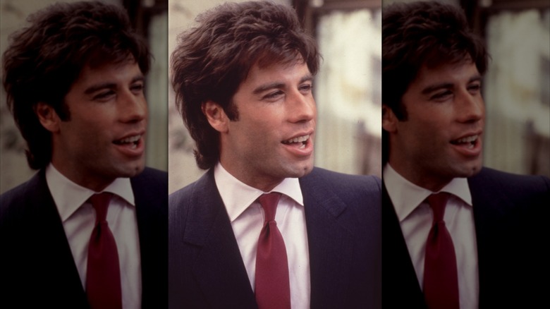John Travolta smiling and posing.
