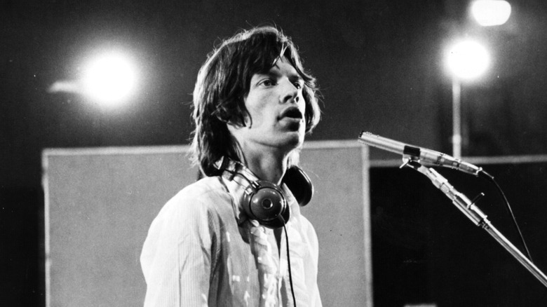 Mick Jagger singing in a recording booth in 1968