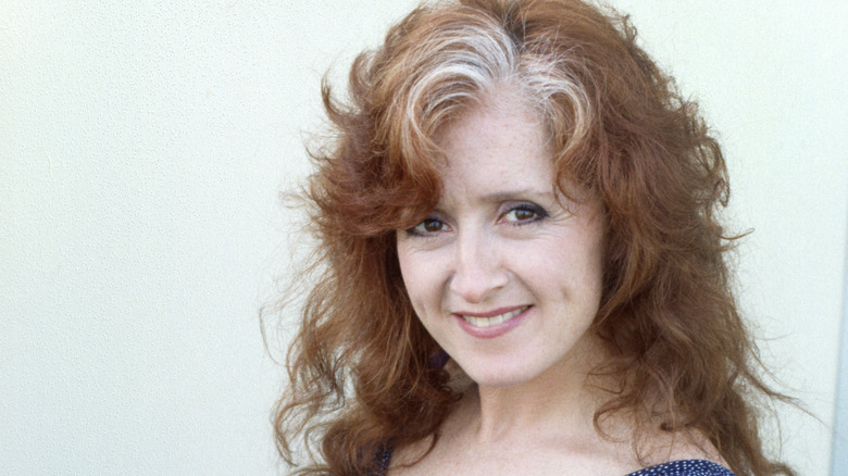 Bonnie Raitt sitting and smiling