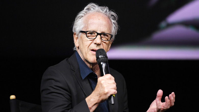 Keith Thibodeaux speaking into a microphone