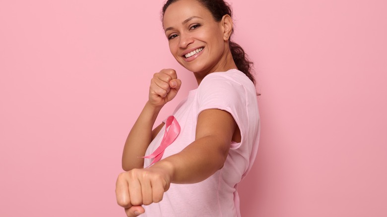Woman wearing pink ribbon for Breast Cancer Awareness