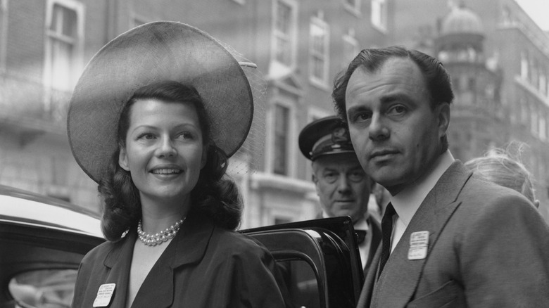 Rita Hayworth in a wide hat beside her husband Prince Aly Khan