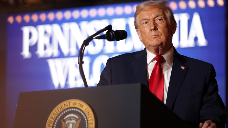 Donald Trump standing behind a podium
