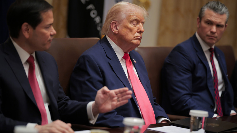 Donald Trump sitting with his eyes closed during a cabinet meeting