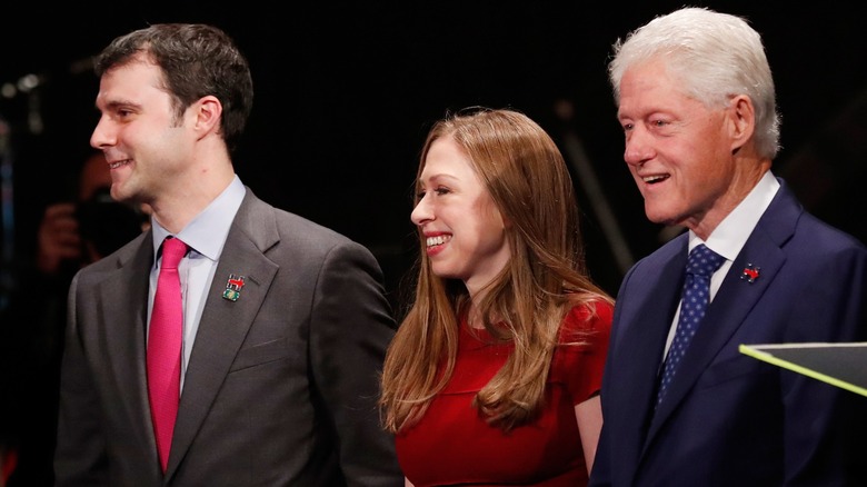 Marc Mezvinsky smiling with Bill and Chelsea Clinton during the 2016 election