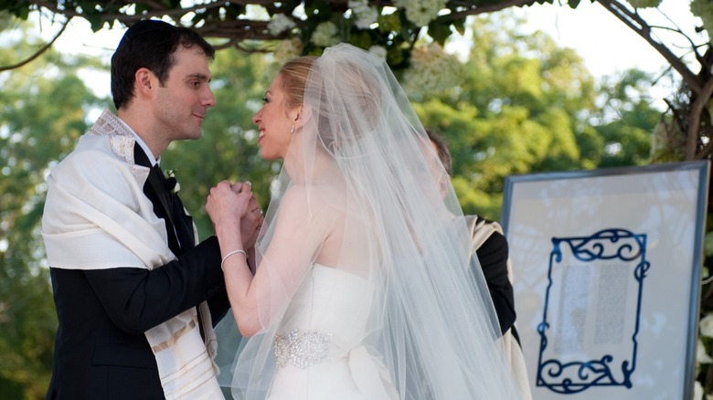 Marc Mezvinsky and Chelsea Clinton smiling on their wedding day in 2010