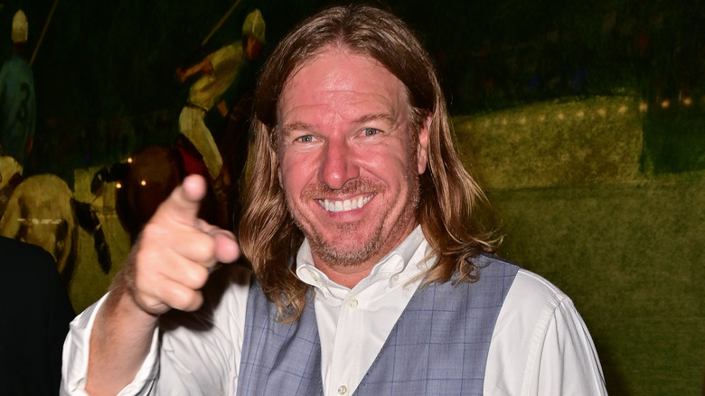 Chip Gaines pointing his finger at the camera outside The Polo Bar in 2021